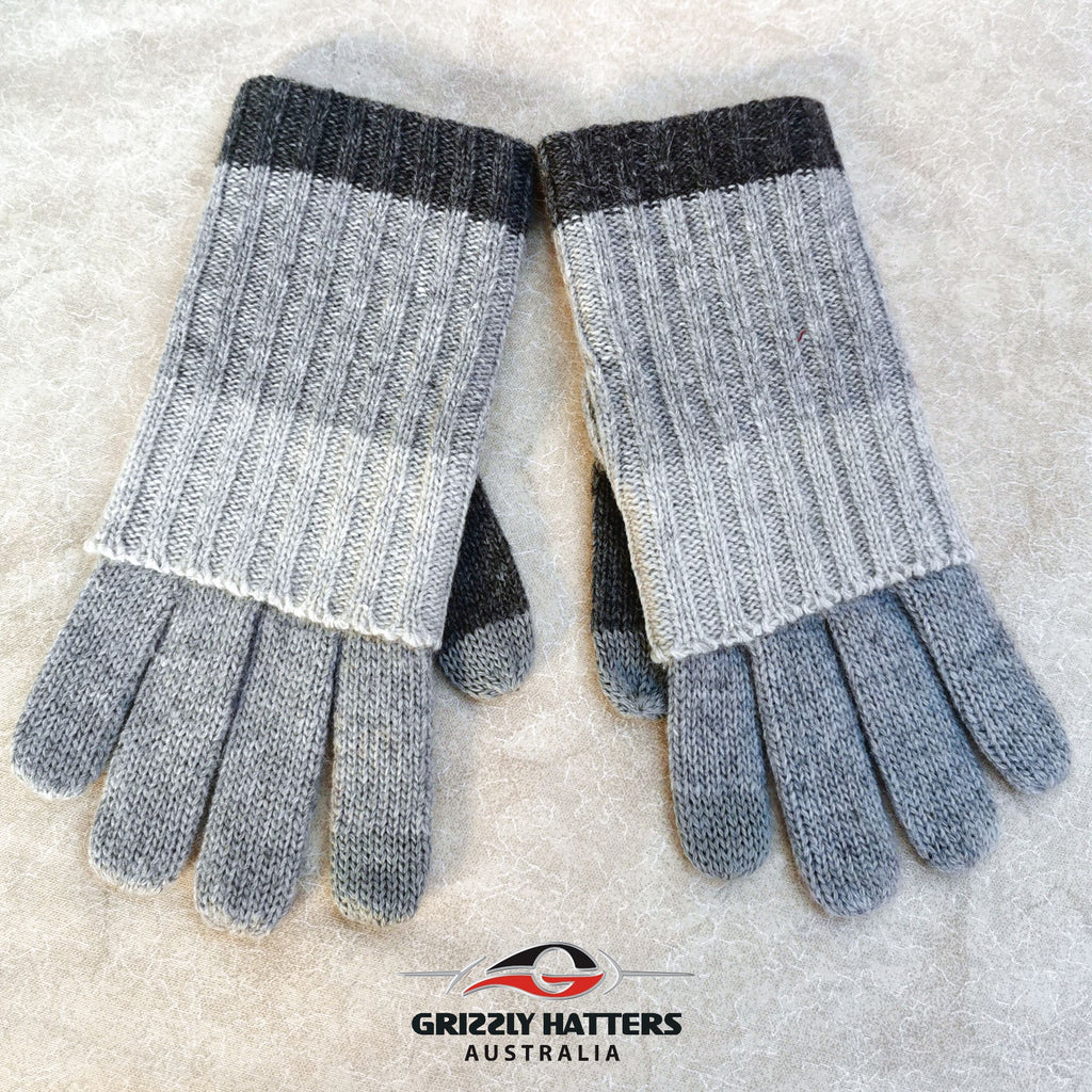 Merino wool touch-screen gloves with long rib cuff folded over hand with thumb hole