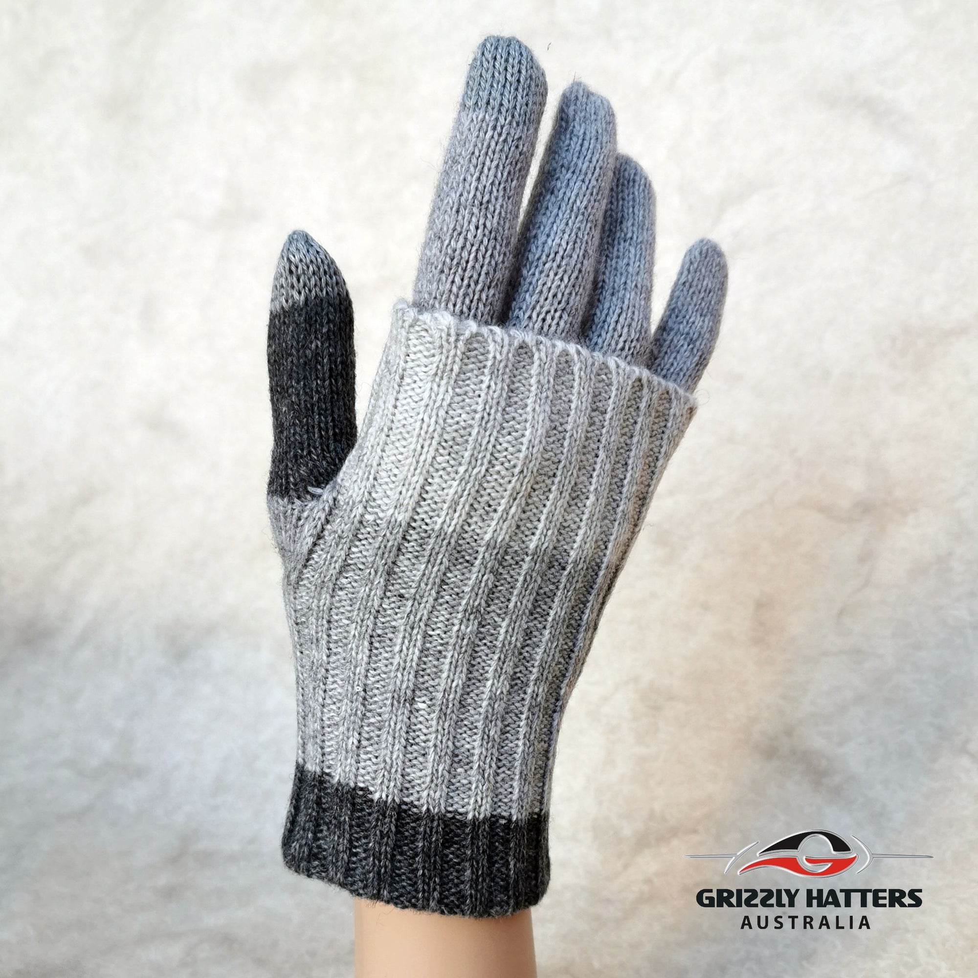 Merino wool touch-screen gloves with long rib cuff folded over hand with thumb hole