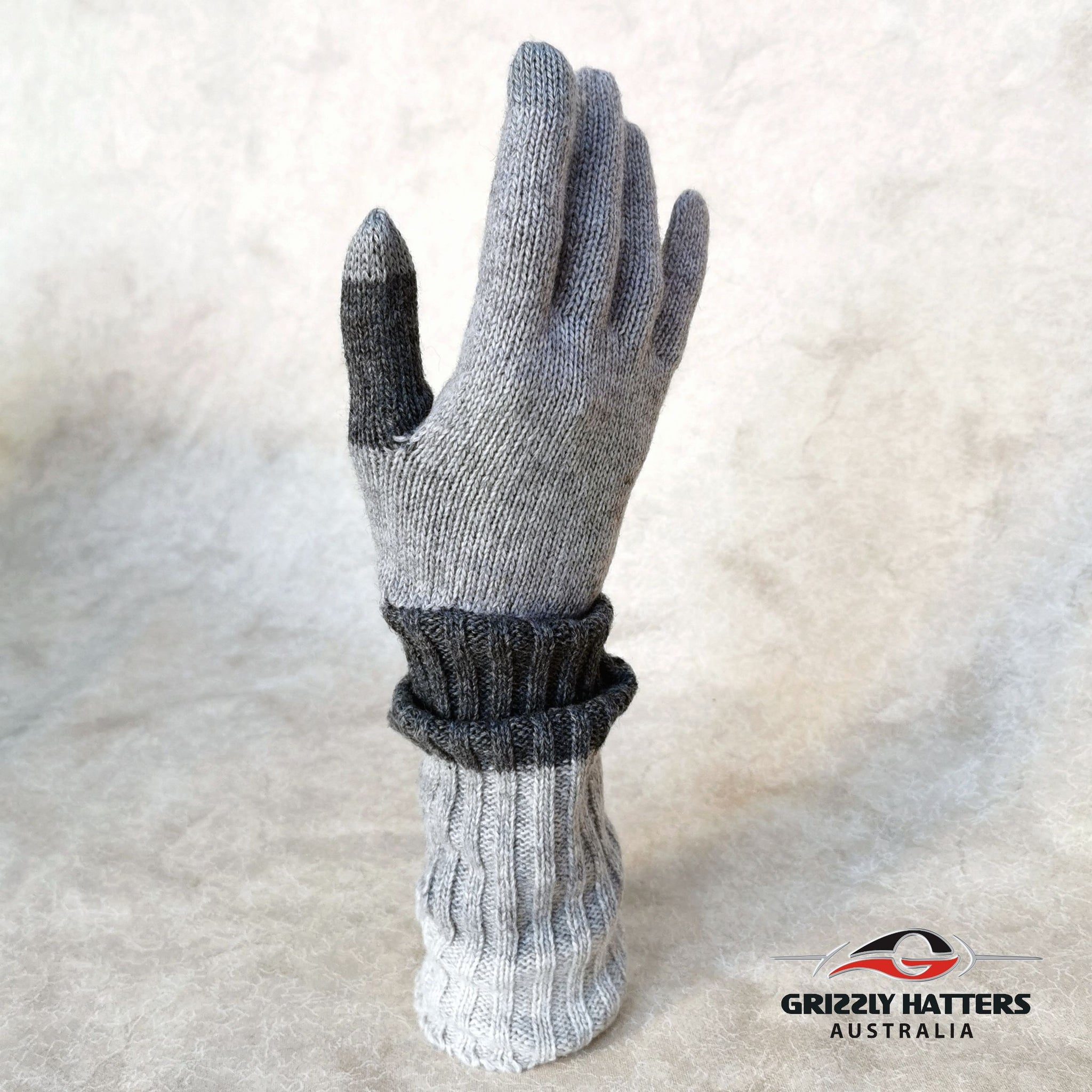 Merino wool touch-screen gloves with long rib cuff folded over hand with thumb hole